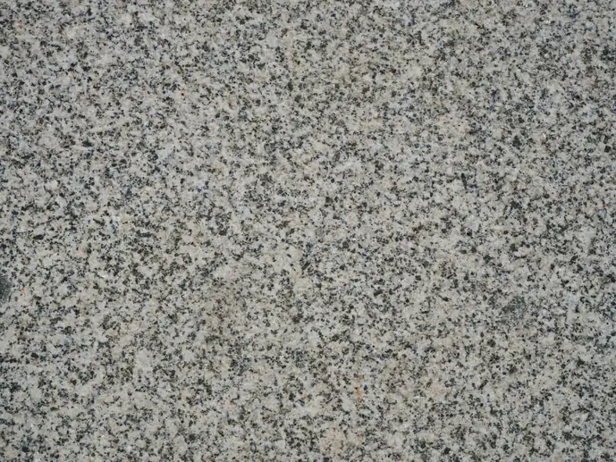 Close-up of speckled grey and white granite countertop surface texture